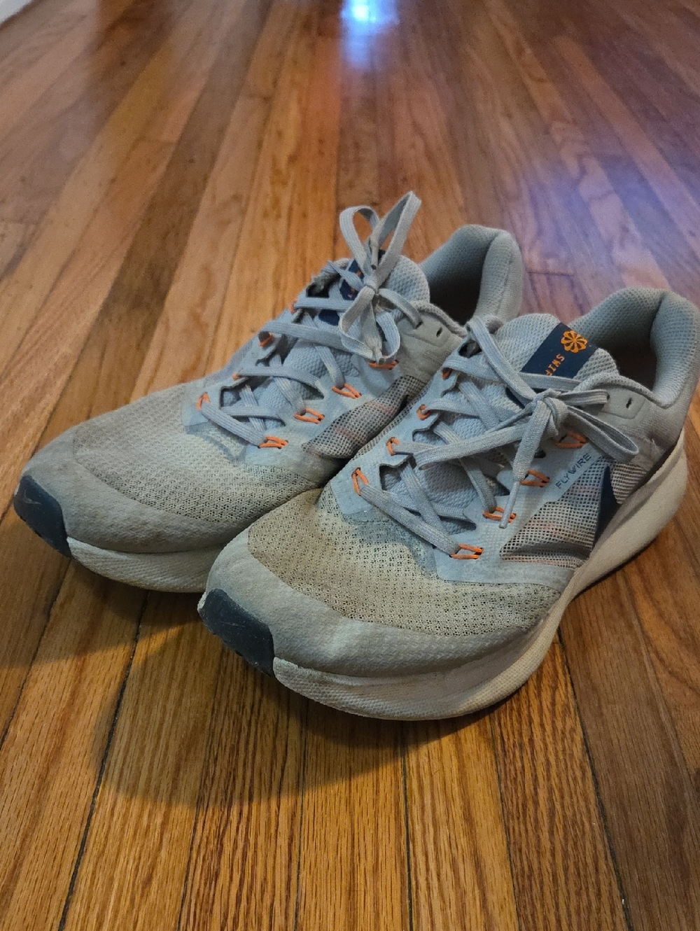 Nike Light Gray Running Shoes with Orange Eyelet Accents